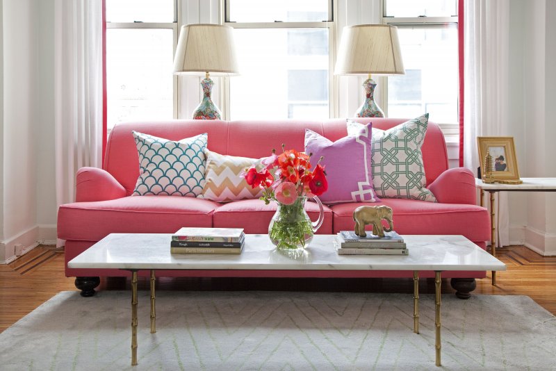 Интерьер гостинной с розовым диваном