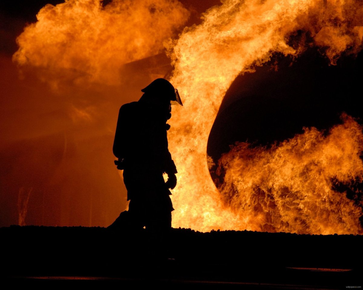Пожарник на фоне огня