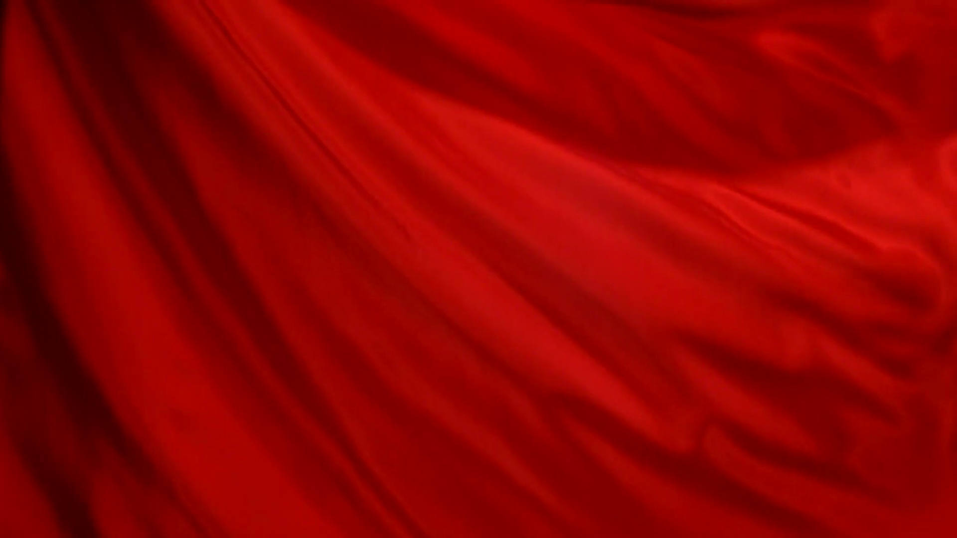 Флаг красный. Красная ткань. Красный шелк. Красная ткань развивается.