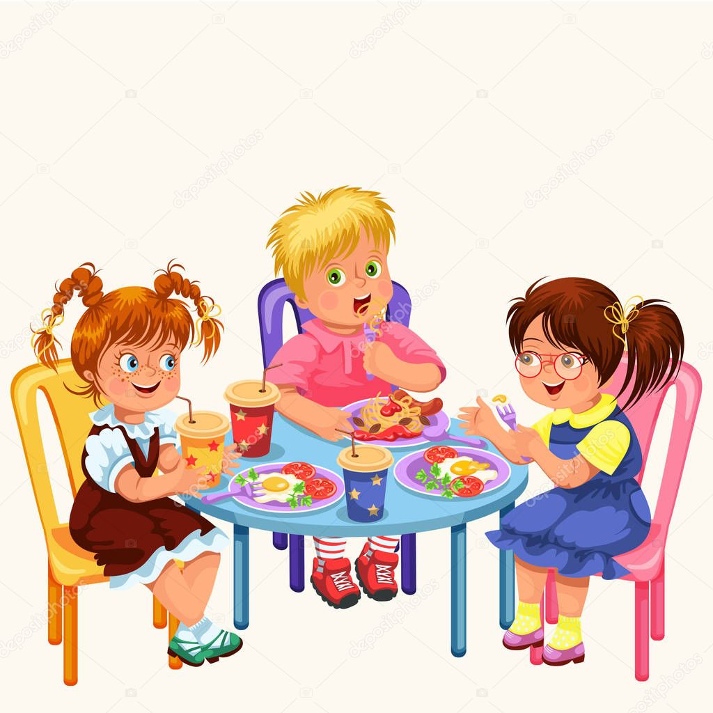 Дети за столом обедают